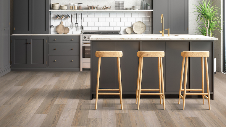 waterproof luxury vinyl plank flooring in a modern kitchen with dark cabinets and island