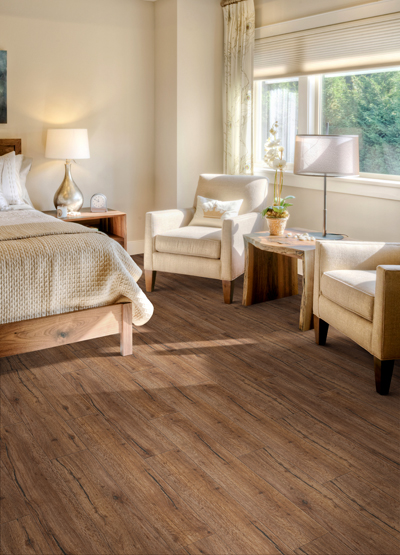 Blinds in a bedroom, white and nude bedding, and wood-look flooring
